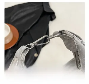 Detailed shot of comfort grey handle and silver metal hardware on tote handbag