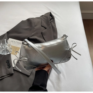 Silver metallic baguette bag with bow details and studs in a Y2K aesthetic