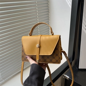 Minimalist two-tone crossbody bag with ginger flap and brown floral monogram pattern