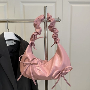 Pink pleated hobo bag with bow details on a metal hanger, cherry blossom color soft leather