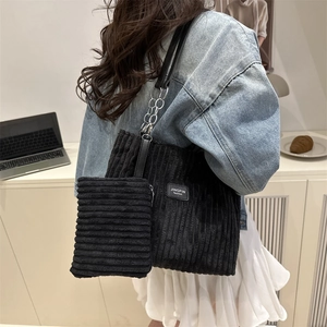 Black corduroy tote bag with metal chain strap and matching small pouch set