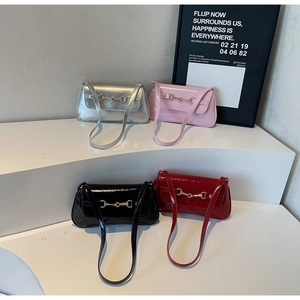 Detail view of four colorful glossy patent leather baguette bags with golden horsebit hardware