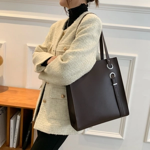 Minimalist large brown PU leather tote bag with silver rings and vertical strap detail