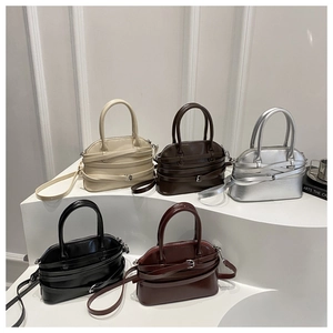 Collection of shell bags in multiple colors displayed on elegant white steps