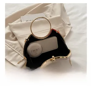Detail view of beige crescent bag showing interior space with phone and golden handle