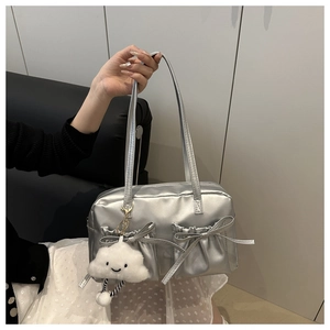 Detail of silver metallic shoulder bag with bow pockets and plush cloud charm