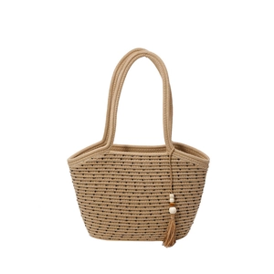 Large woven straw beach bag with black polka dot lines and wooden bead tassels