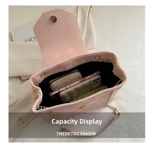 Pink snake texture handbag showing spacious interior for wallet, phone and daily items