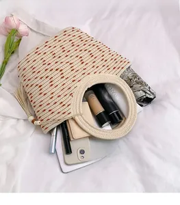 Top view of spacious woven tote bag with round handles, tassels and inner storage capacity