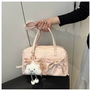 Detail of pink PU pillow bag featuring double bow pockets and cute cloud plush charm