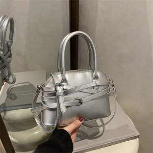 Metallic silver handbag with cross strap design and metallic buckles for fashion commute