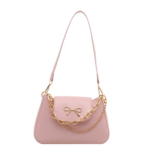 Pink underarm bag with golden bow and double chain detail for women in 2025 style