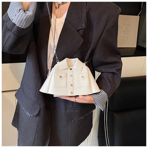 Detail of creative white blazer-shaped crossbody bag with metal buttons and chain strap