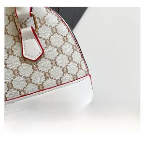 Detail of white lychee leather texture with brown patterns and red edge finishing
