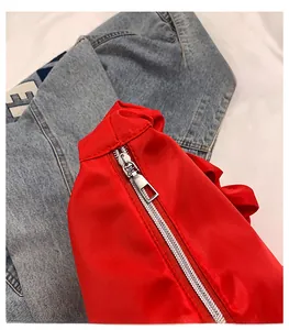 Detail of premium silver metal zipper on red ruched nylon bag with glossy finish