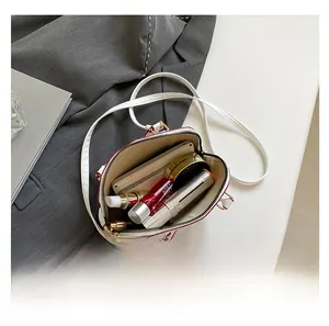 Interior view showing the large capacity and storage of the white shell handbag