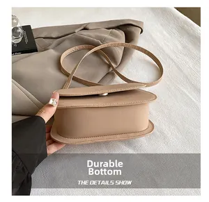 Detail of the wear-resistant bottom on this minimalist beige faux leather saddle bag