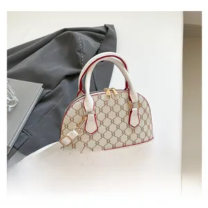 Macro view of shell crossbody bag with retro logo print and red trim edges