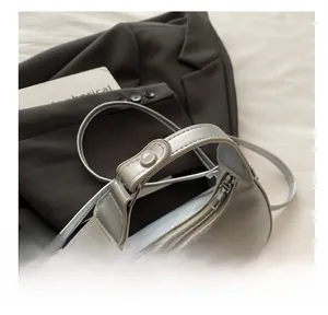 Close-up of the comfortable silver faux leather handle with delicate white lace trim