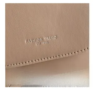 Detail of light brown leather saddle bag with Fashion Trend 1996 embossed lettering