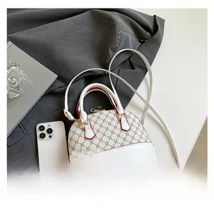 Size comparison of monogram shell bag with a smartphone and red edge detailing