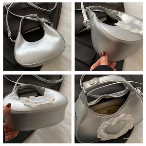 Silver crescent bag with lace heart detail, showing multiple views and interior space