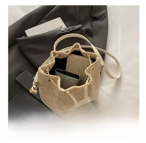 Internal capacity of woven bucket bag showing phone and wallet for daily essentials