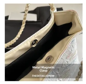 Close-up of the magnetic closure and woven texture on a large minimalist tote bag