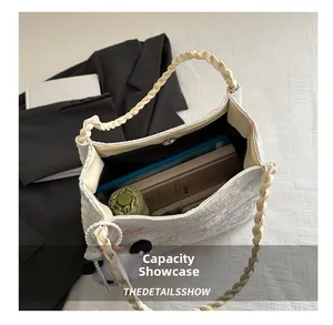Top-down view of large capacity cream woven tote bag with braided handles showing inner storage