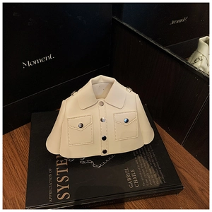 Detail of creative shirt-shaped crossbody bag with metal buttons and chain strap