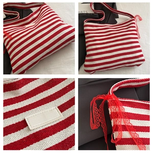 Detail of red and white striped knit tote bag with lace ribbon and blank leather patch