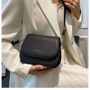 Detail of black crossbody bag with white logo and adjustable shoulder strap for women
