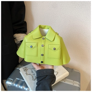 Detail of neon green jacket-shaped mini crossbody bag with silver chain strap and buttons