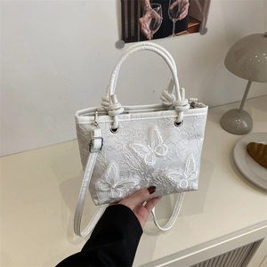 White lace butterfly bucket bag with delicate floral embroidery and elegant top handle