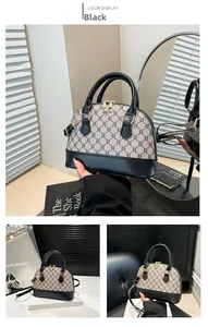 Detail view of black shell bag with monogram texture and adjustable shoulder strap
