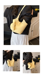 Detail of light yellow bucket bag featuring lychee grain leather and round coin purse