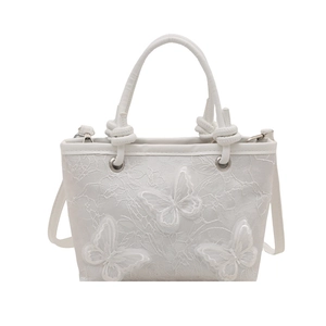 White floral lace tote bag featuring 3D butterfly embroidery and elegant knot handle