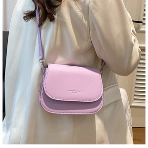 Detail of trendy purple crossbody square bag with Fashion Trend white typography