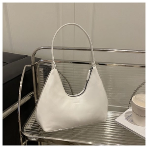 Close-up of white leather crescent hobo bag featuring fine stitching and fashion embossed logo