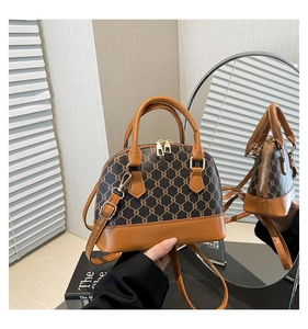 Detail of vintage monogram shell bag showing side structure via mirror reflection