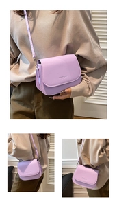 Detail view of lavender saddle bag showing front logo and adjustable shoulder strap