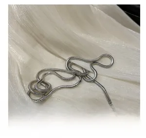 Close-up of sleek silver snake chain strap with textured round metallic accents