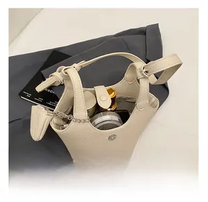 Close-up of beige leather bucket bag interior showcasing spacious storage for cosmetics
