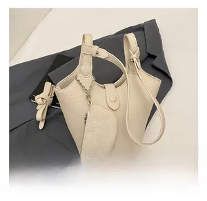 Detail of cream white lychee grain bucket bag with chain strap and small round coin purse