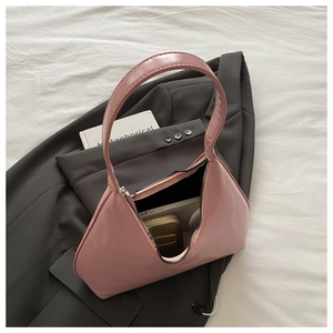 Pink hobo handbag interior showing practical capacity with wallet and books