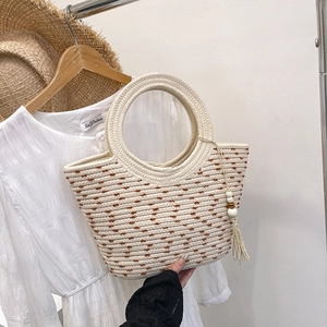 Large beige woven tote bag with brown embroidery and beaded tassel for summer vacation