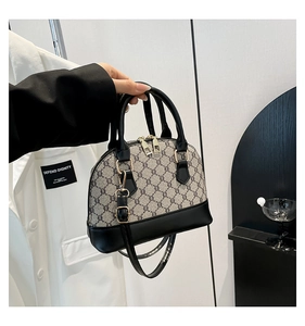 Macro detail of monogram shell bag with premium leather handles and golden zip hardware