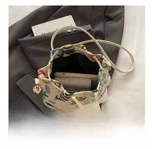 Interior view of floral weave bucket bag showing space for phone and wallet essentials