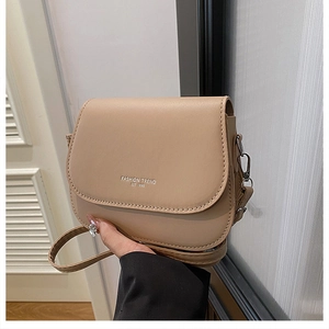 Detail of khaki PU leather crossbody bag featuring the Fashion Trend 1996 logo engraving