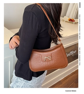 Brown crocodile pattern faux leather handbag with a stylish gold bow metal buckle detail